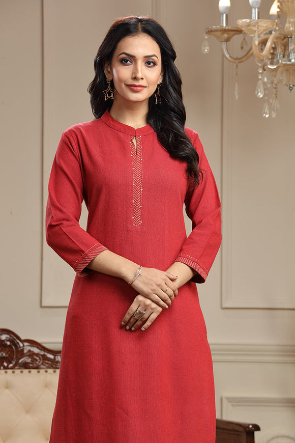 A graceful woman wearing a handwoven plain long kurta in a beautiful hue, adorned with intricate thread work on the neckline, cuffs, and hem. The kurta drapes elegantly, reflecting the timeless charm of traditional craftsmanship and modern style.